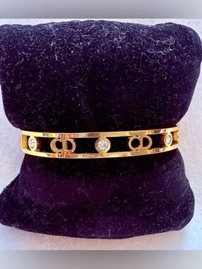 Gold-Tone Interlocking Circle Bracelet with Black Enamel and Crystals